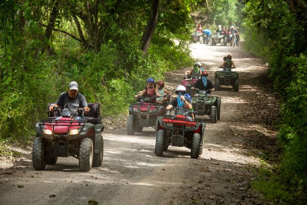 Grupo de cuatrimotos en un camino de montaña sombreado en el tour en ATV de Puerto Vallarta